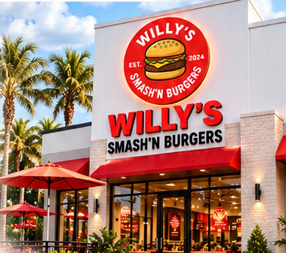 Willy's Smash'N Burgers corner restaurant with lighted logo sign, red awnings and palm trees